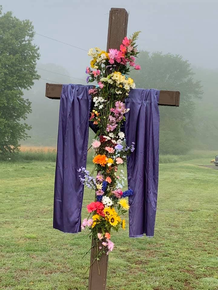 Wooden cross beneath a dramatic sky